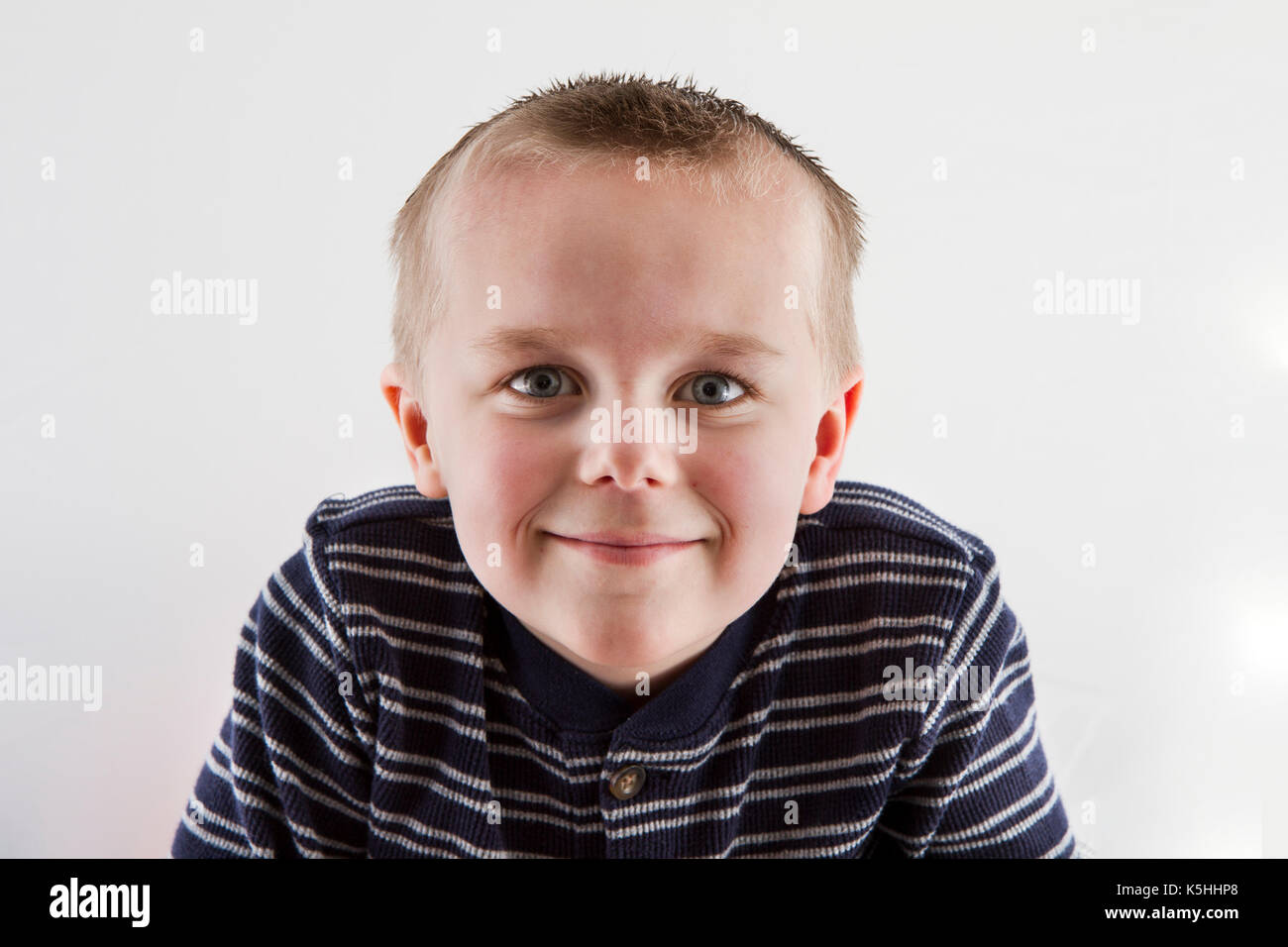 Young boy smiling at the camera Stock Photo - Alamy