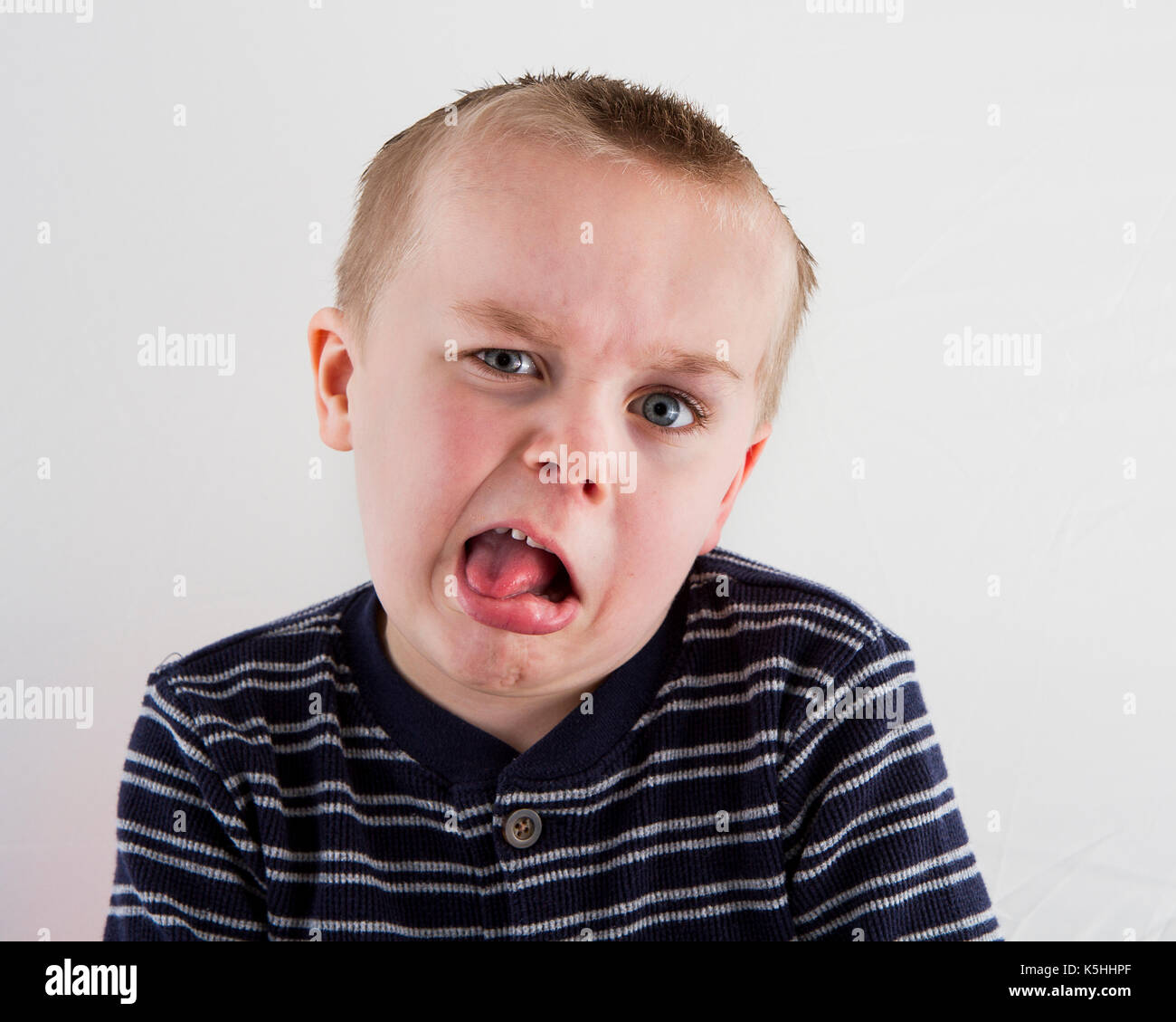 Young boy looking at the camera having a fun time making faces Stock Photo
