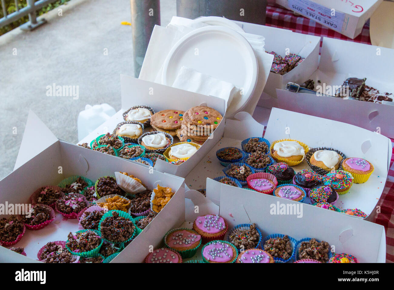 Cakes in a box on the cake stall at an Australian school fete, available for sale to help raise funds for the school Stock Photo