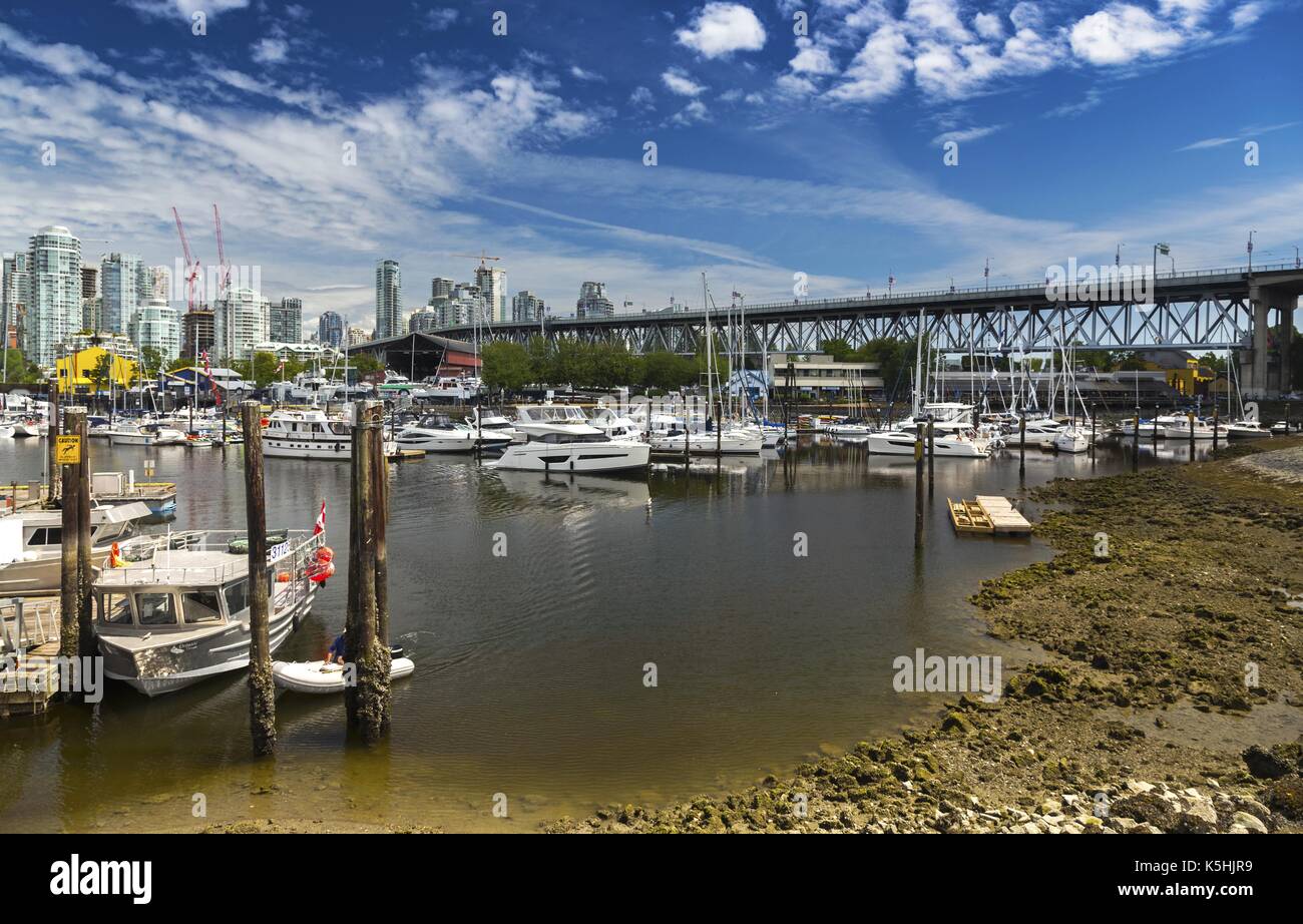 Landscape View of Granville Bridge, Fisherman Wharf, Granville Island and Marina from False Creek Seawall in Vancouver British Columbia Canada Stock Photo