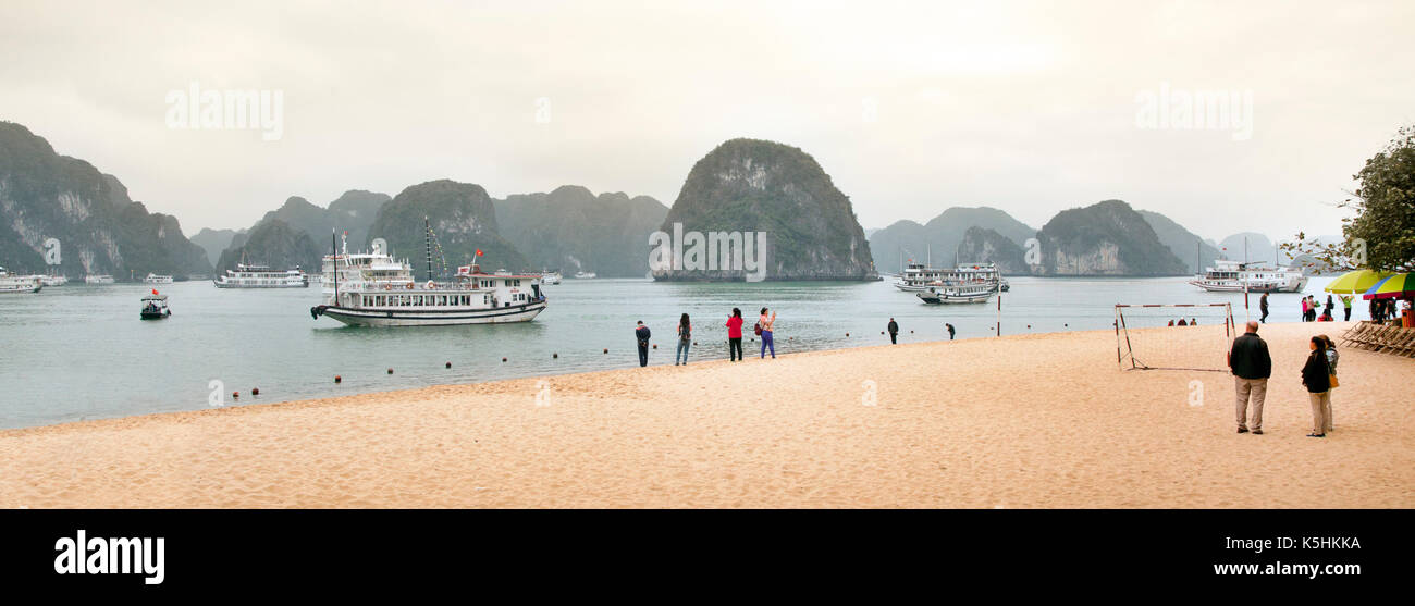 Titov Island, Halong Bay, Vietnam, beach scene with tourists and tour boats. Stock Photo