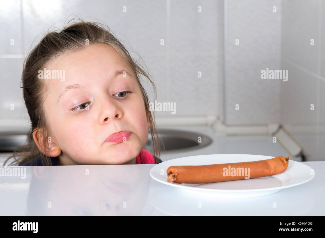 Little girl sees the sausage Stock Photo Alamy