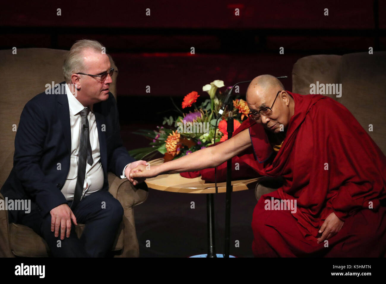 The Dalai Lama with Richard Moore as he addresses a charity event marking the 20th anniversary of the charity Children in Crossfire to celebrate 20 years of the ground-breaking organisation's work, at the Millennium Forum, during a visit to Londonderry. Stock Photo