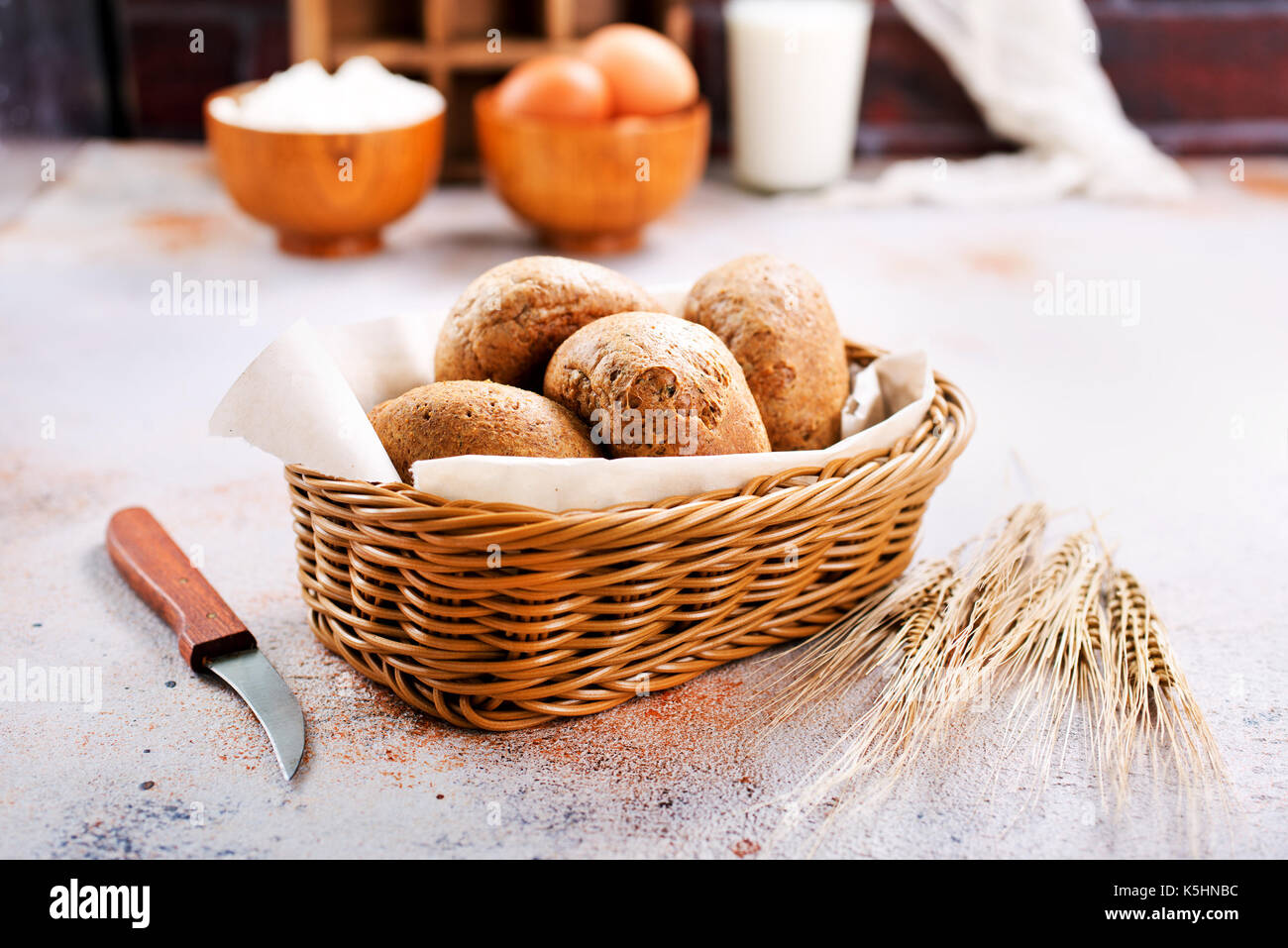 fresh bread in basket and on a table Stock Photo