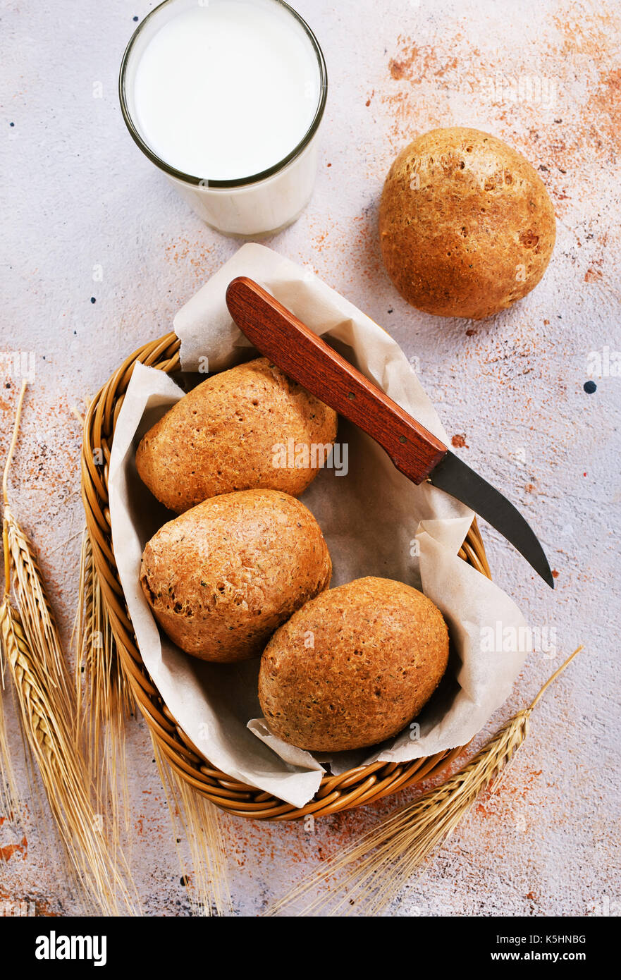 fresh bread in basket and on a table Stock Photo