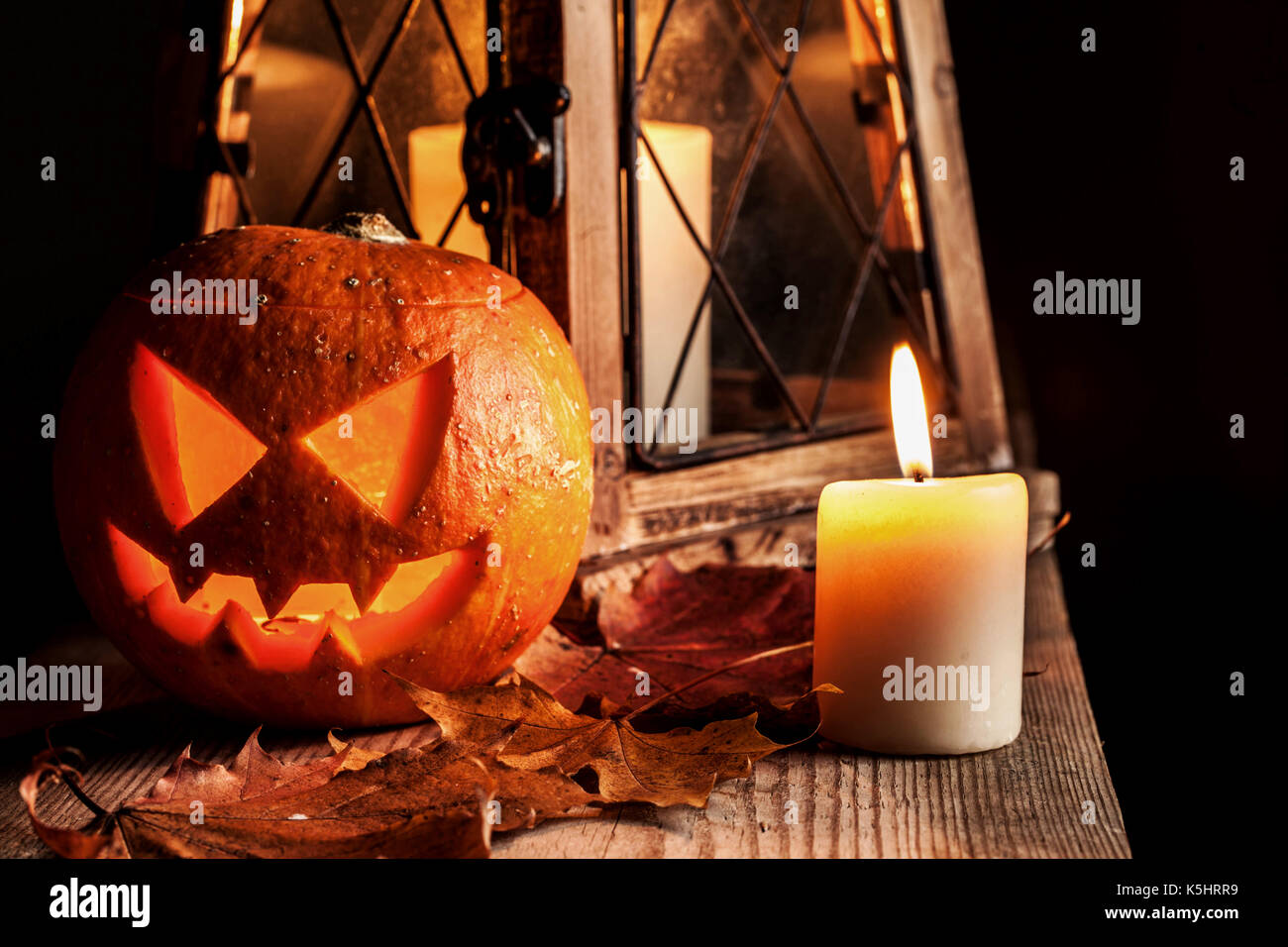 Halloween pumpkin and lantern with candle on black background Stock Photo