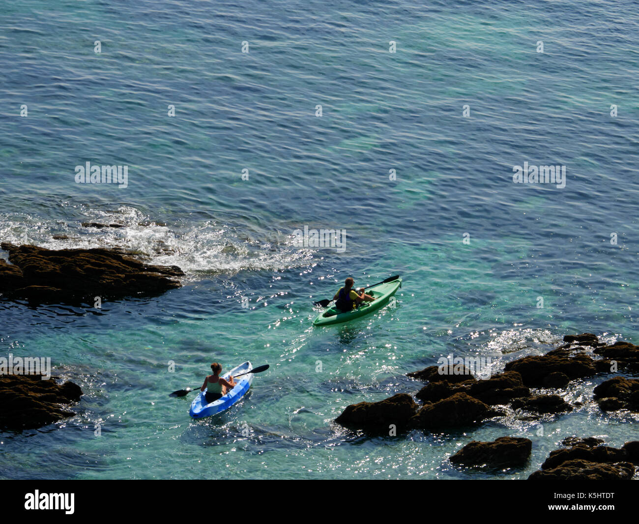 Sea kayaking off the coast near Gorran Haven, Cornwall. Stock Photo