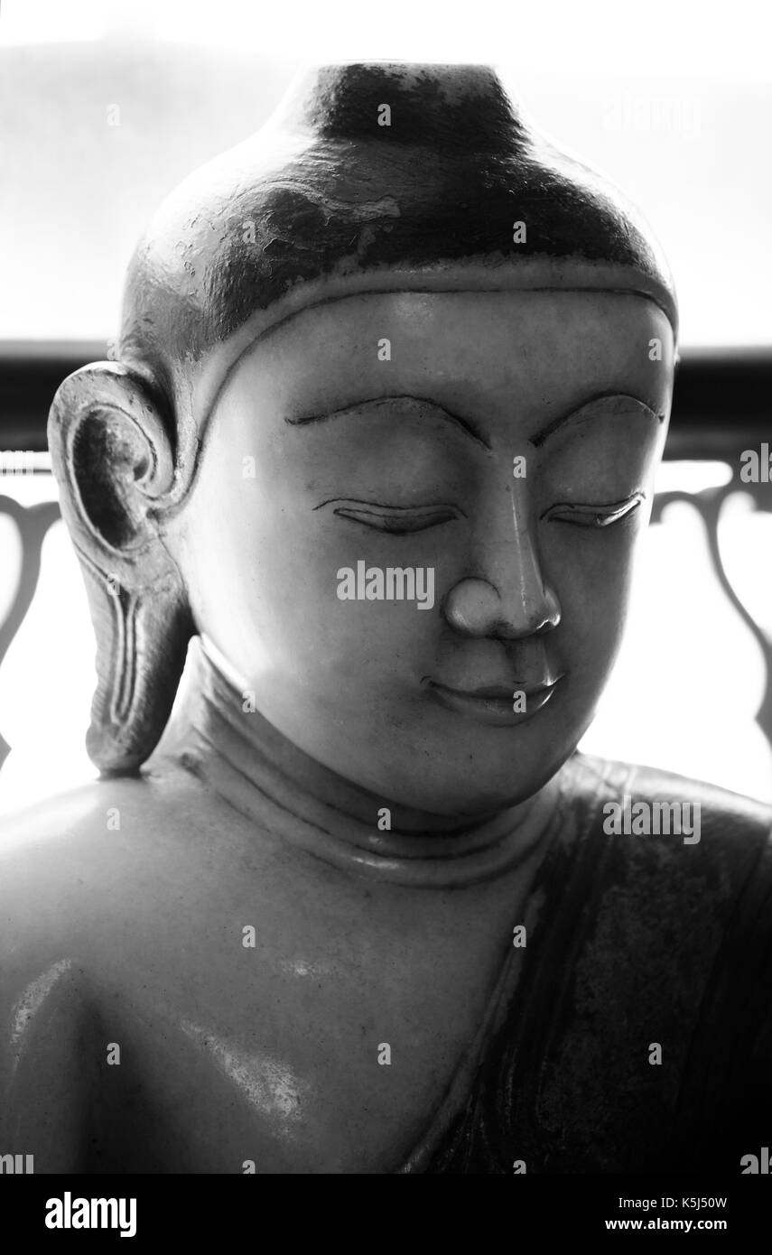 A marble statue of Buddha from Burma, Myanmar. Thought to be from 18th or 19th century it is now displayed in the Wisbech and Fenland  Museum. Stock Photo