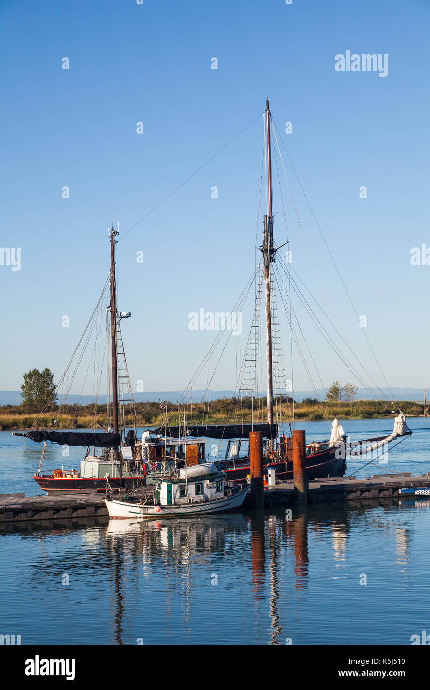 Twin masted ketch and a small Japanese fishing boat at dock in Steveston Stock Photo