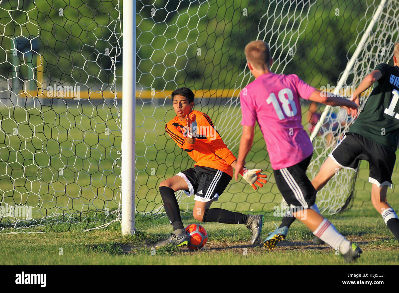Keeper unable to make a stop on a shot that went between his legs and into  the net for a goal Stock Photo - Alamy