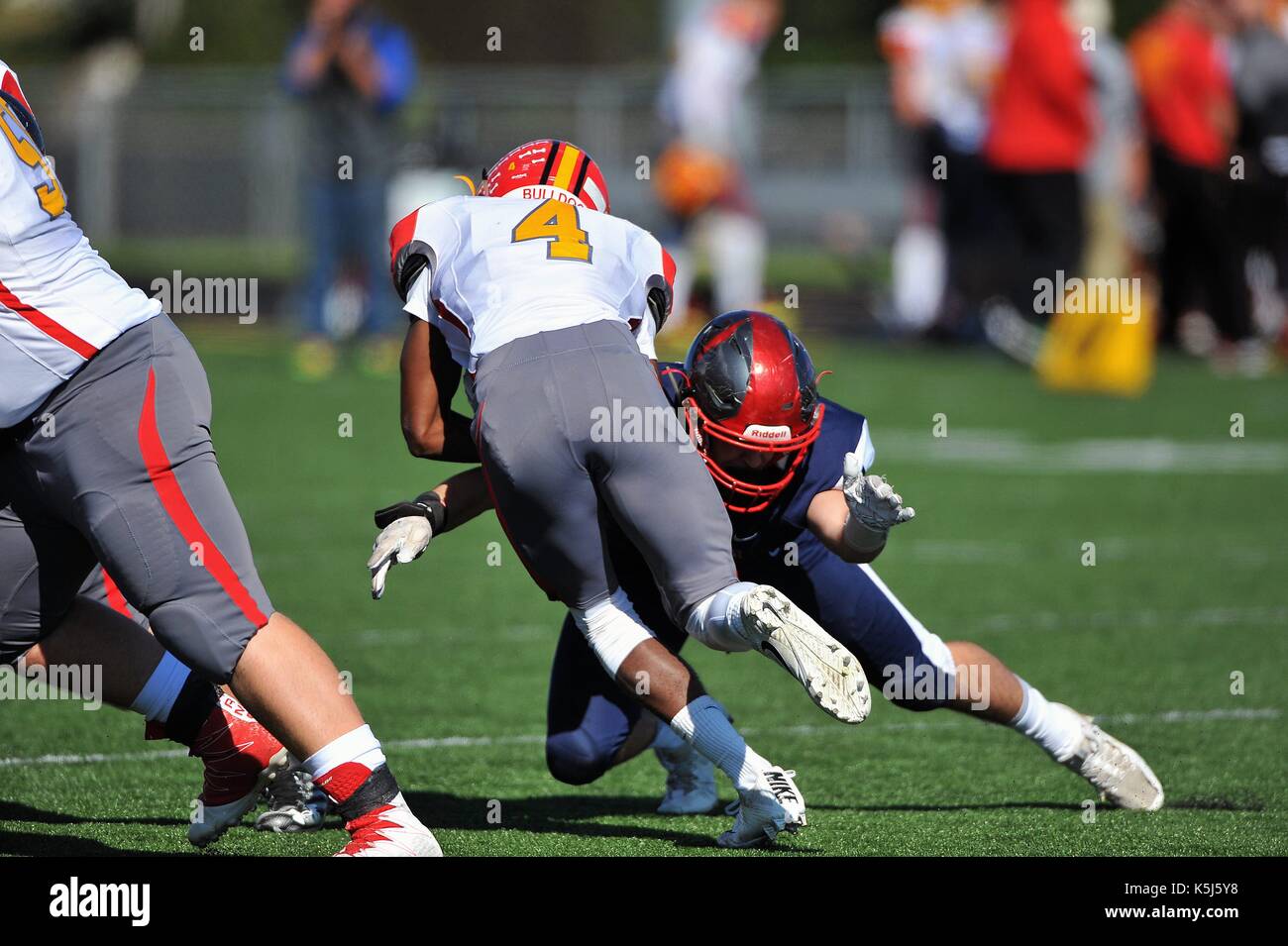 Player well positioned to make a tackle during a high school football game. USA. Stock Photo
