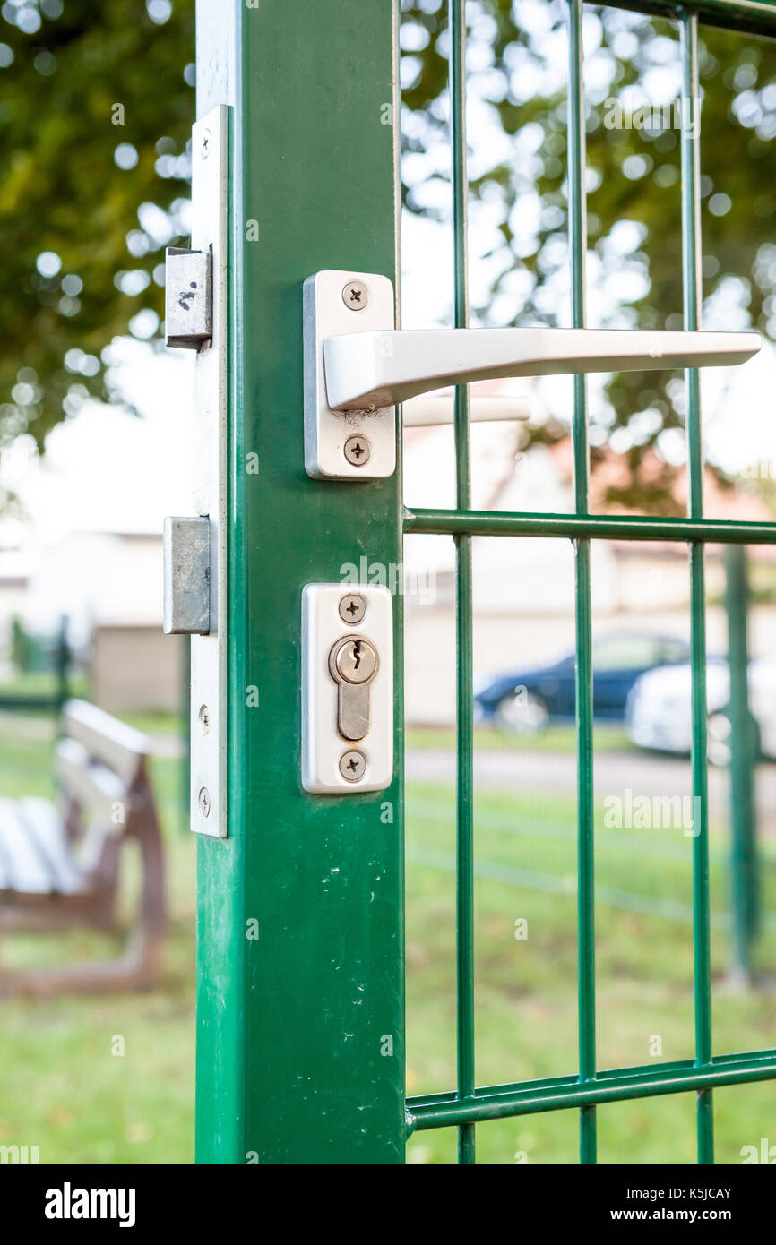 an security lock with cylinder and an handle in an iron fences Stock Photo