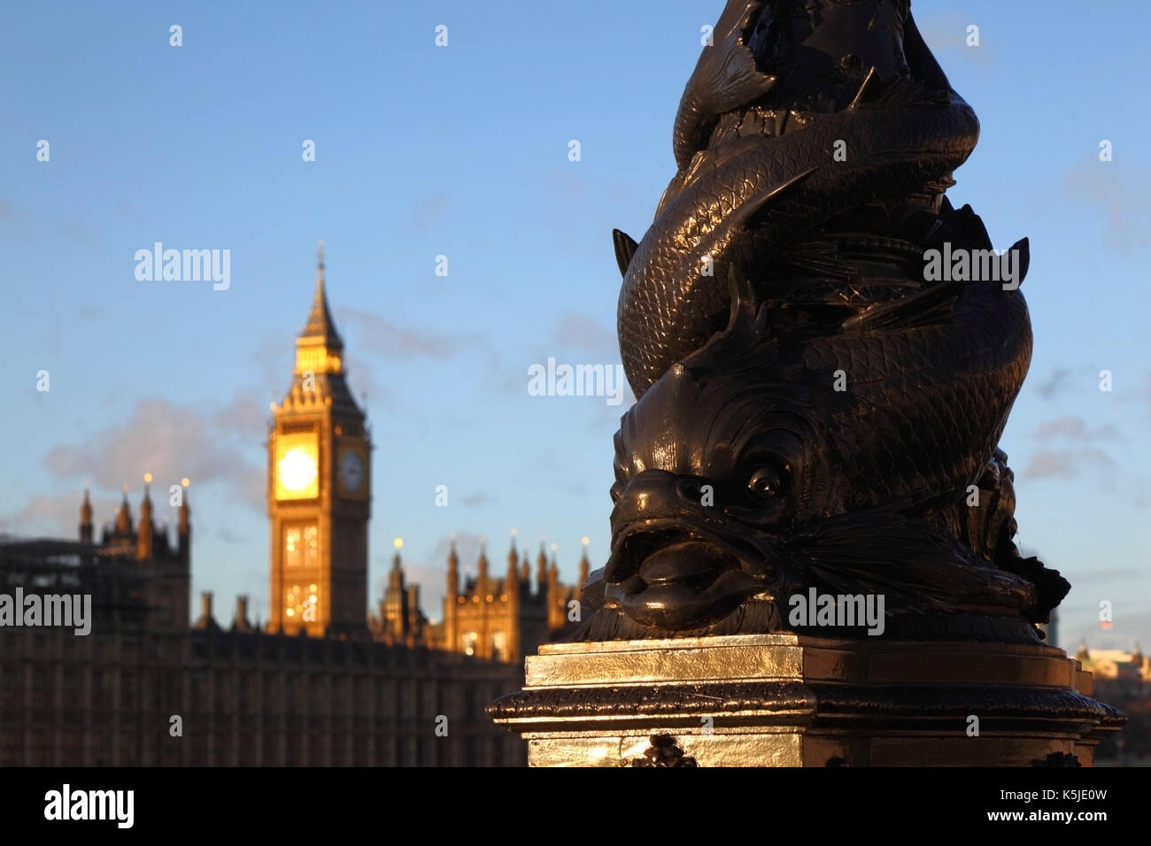 Vulliamy dolphin lamp on Albert Embankment , Big Ben and Palace of Westminster in background, London, England Stock Photo
