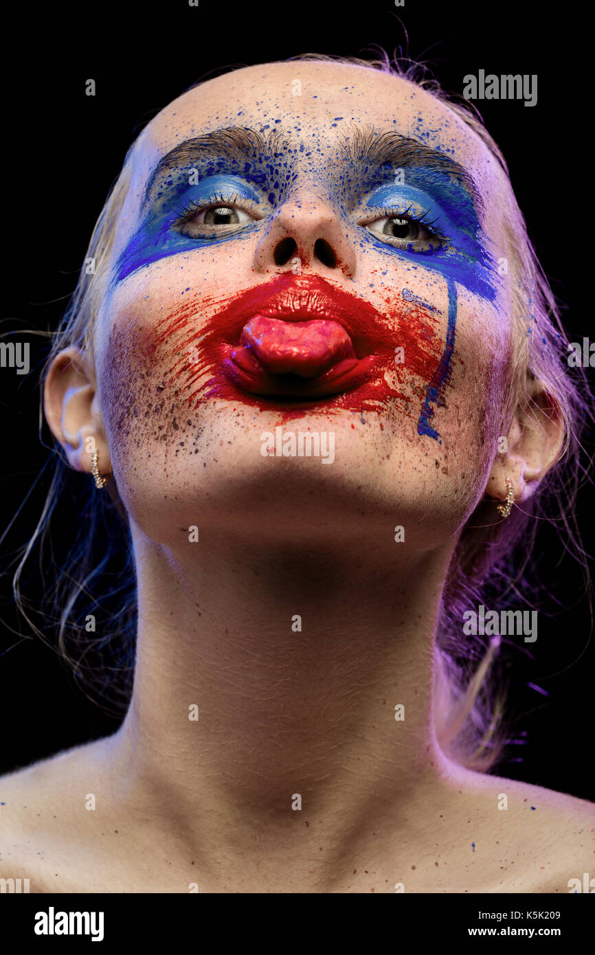 female portrait with creative multicolored makeup on black background Stock Photo