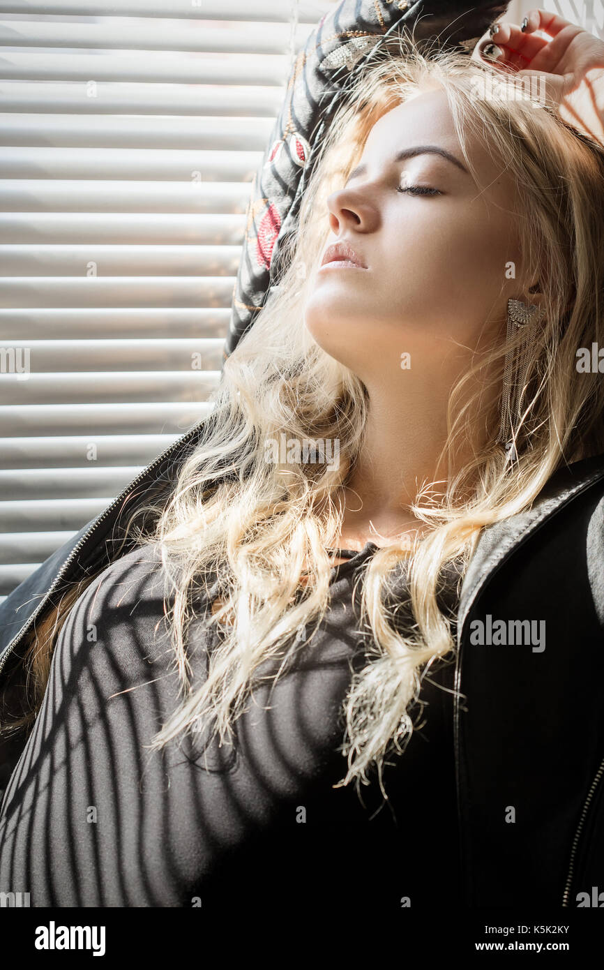 sensual aroused girl sitting on window in sunlight with blinds Stock ...