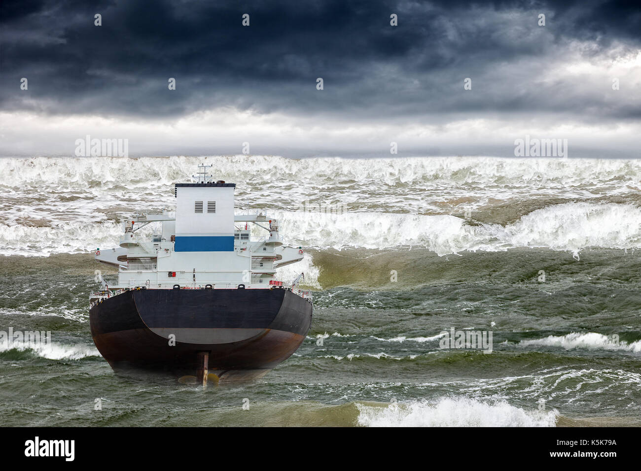 Tsunami disaster that threatens a ship on sea. Stock Photo