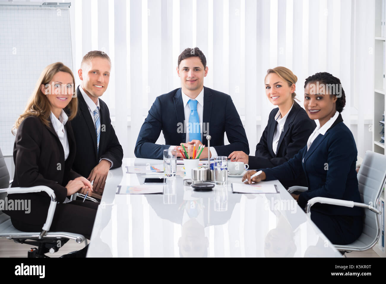 Happy Male And Female Businesspeople Attending Seminar Stock Photo - Alamy