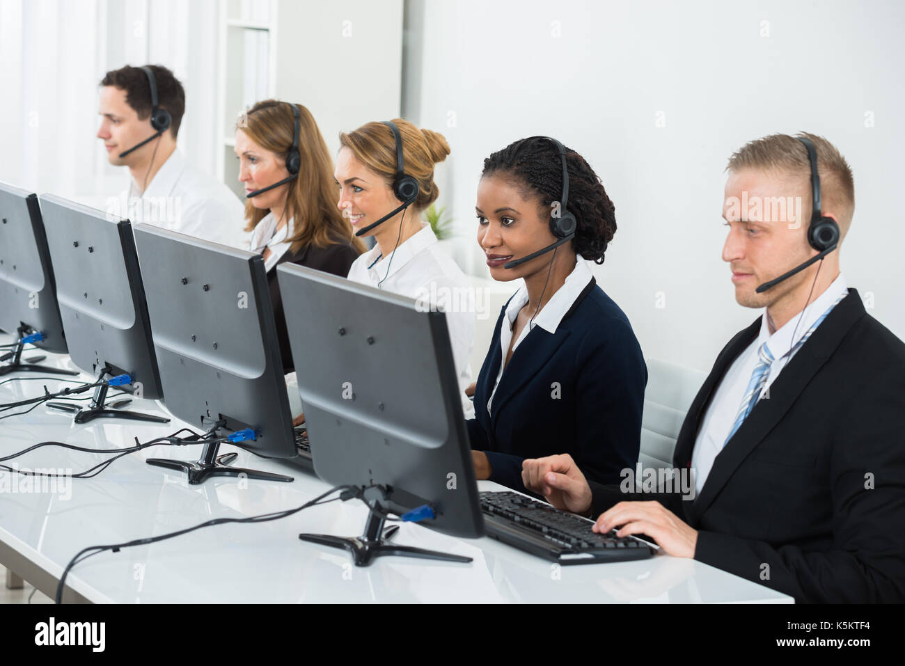 Business People Wearing Headset Celebrate Working Office Call Center  Telemarketing Stock Photo by ©BiancoBlue 665363060