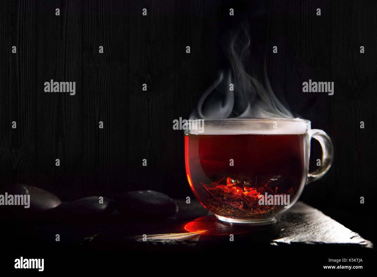 A beautiful, hot, black tea from India on a black flone made of stone