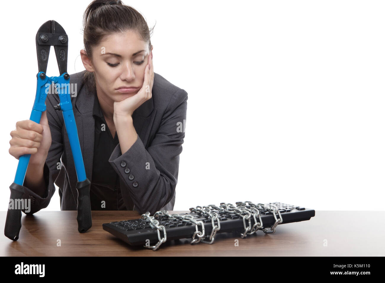 Computer keyboard locked up and business woman holding bolt cutters not