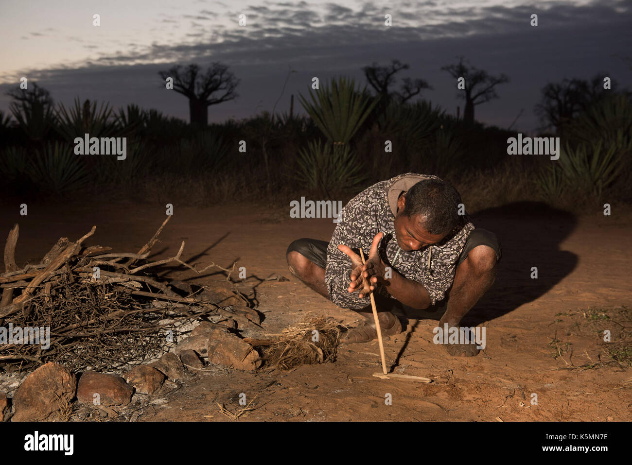 Antandroy man making a fire with sticks, Mandrare River Camp, Ifotaka Community Forest, Madagascar Stock Photo