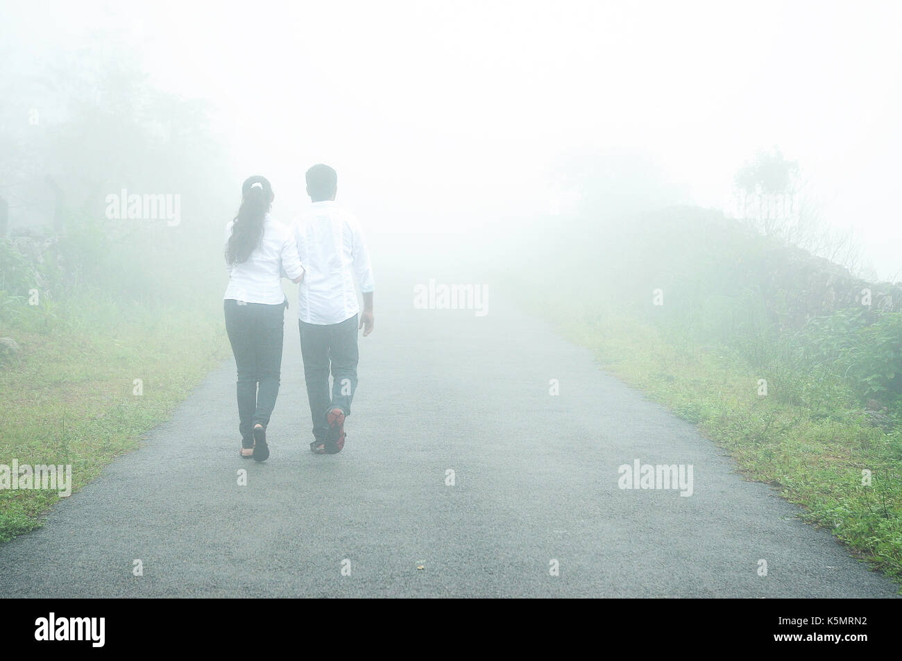 couple holding hands and walking forest road Stock Photo - Alamy