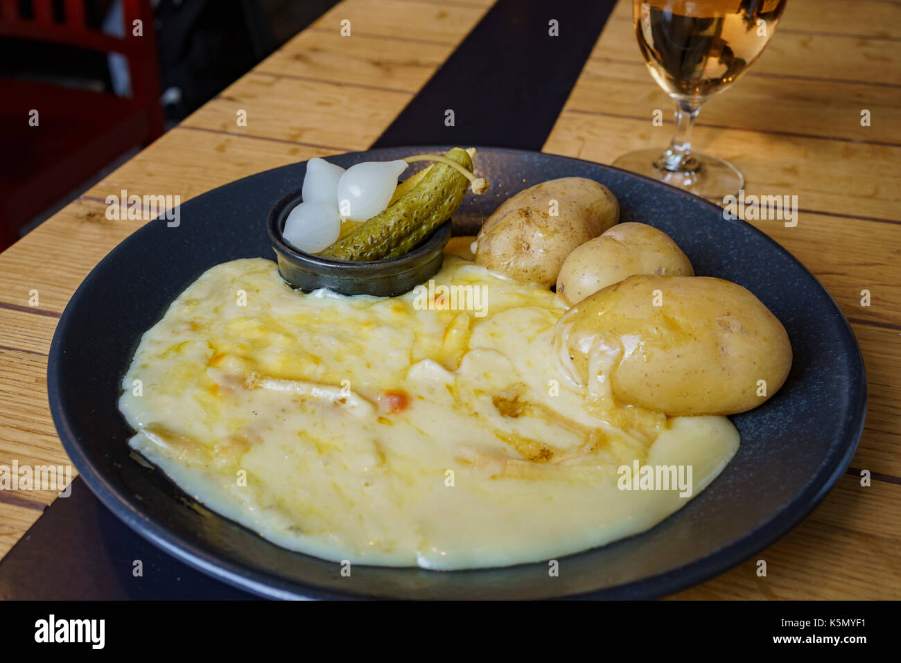 The famous dish of cheese and potato, serve with wine, ate at Zurich