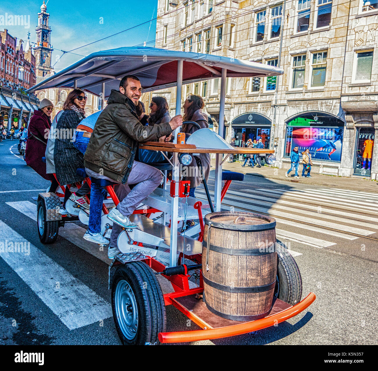 Amsterdam, Netherlands - Mar 26, 2016: Mobile peddle driven tavern drives down street Stock Photo