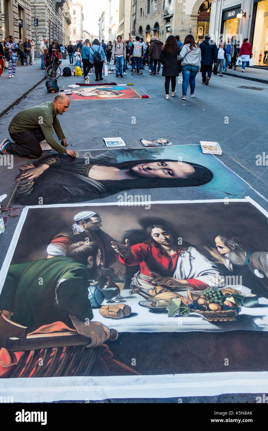 Florence, Italy - Apr 23, 2017: Man recreates famous paintings in chalk on the street Stock Photo