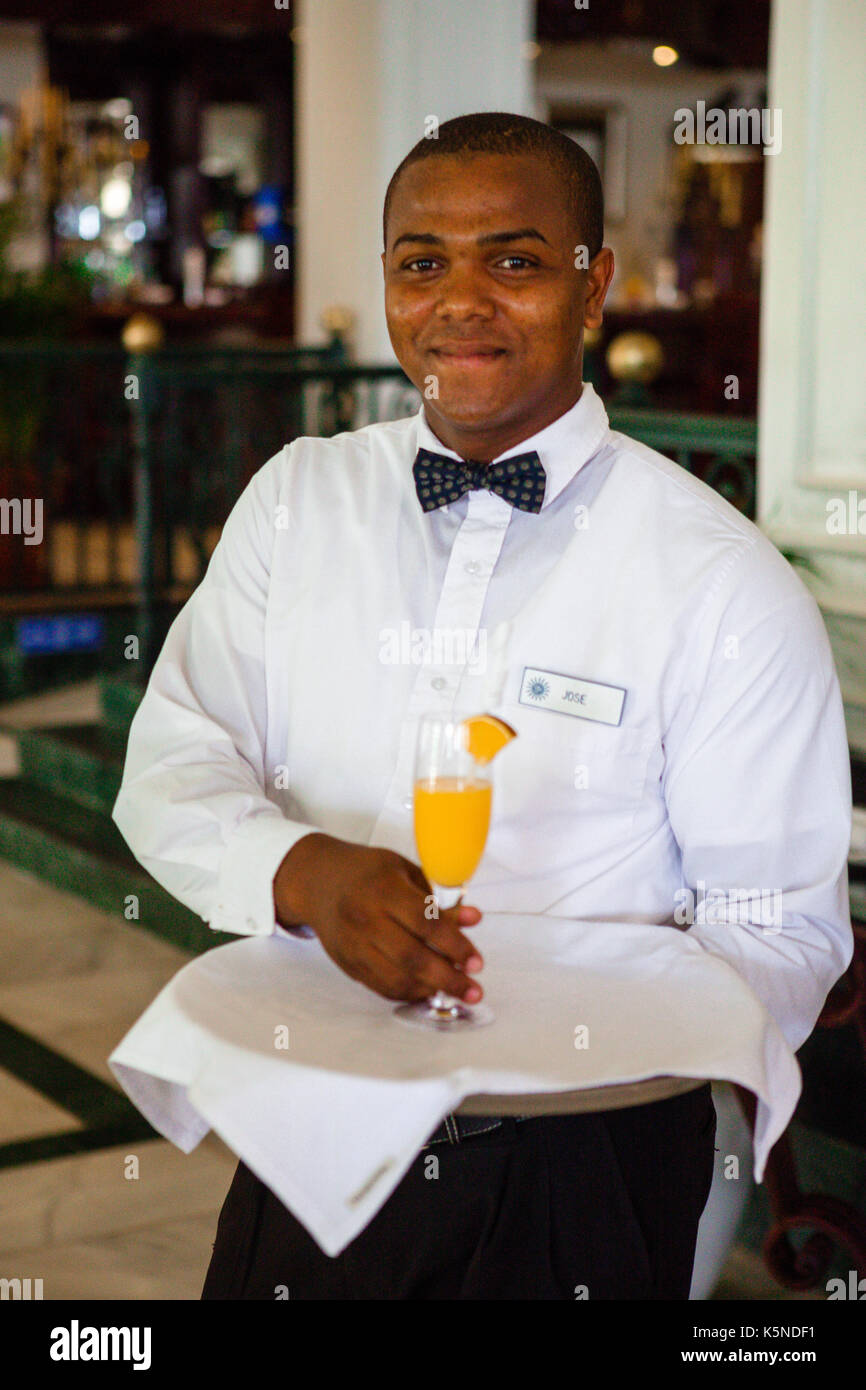 Waiter welcoming with juice Stock Photo