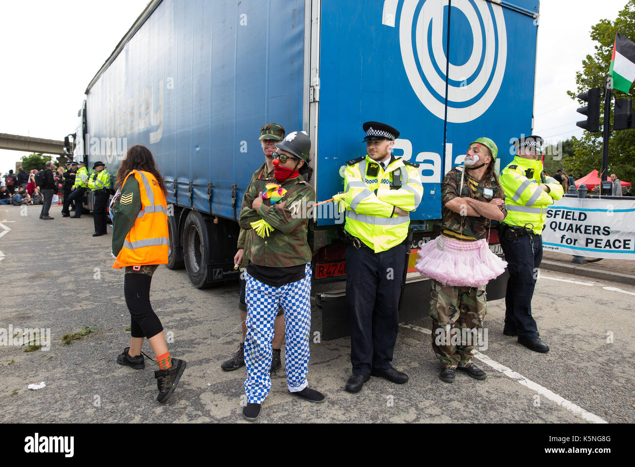 London, UK. 9th September, 2017. The Clandestine Insurgent Rebel Clown Army performs in front of the police and activists from many different campaign and faith groups protesting outside the ExCel Centre against the arms trade and the arms fair to be held at the venue next week. DSEI is the world's largest arms fair and military delegations invited by the British government include states named by the Foreign Office as a 'human rights priority', namely Bahrain, Colombia, Egypt, Pakistan and Saudi Arabia. Credit: Mark Kerrison/Alamy Live News Stock Photo