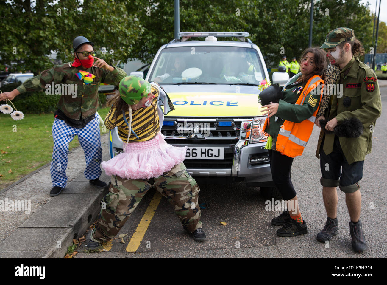 London, UK. 9th September, 2017. The Clandestine Insurgent Rebel Clown Army performs in front of the police and activists from many different campaign and faith groups protesting outside the ExCel Centre against the arms trade and the arms fair to be held at the venue next week. DSEI is the world's largest arms fair and military delegations invited by the British government include states named by the Foreign Office as a 'human rights priority', namely Bahrain, Colombia, Egypt, Pakistan and Saudi Arabia. Credit: Mark Kerrison/Alamy Live News Stock Photo