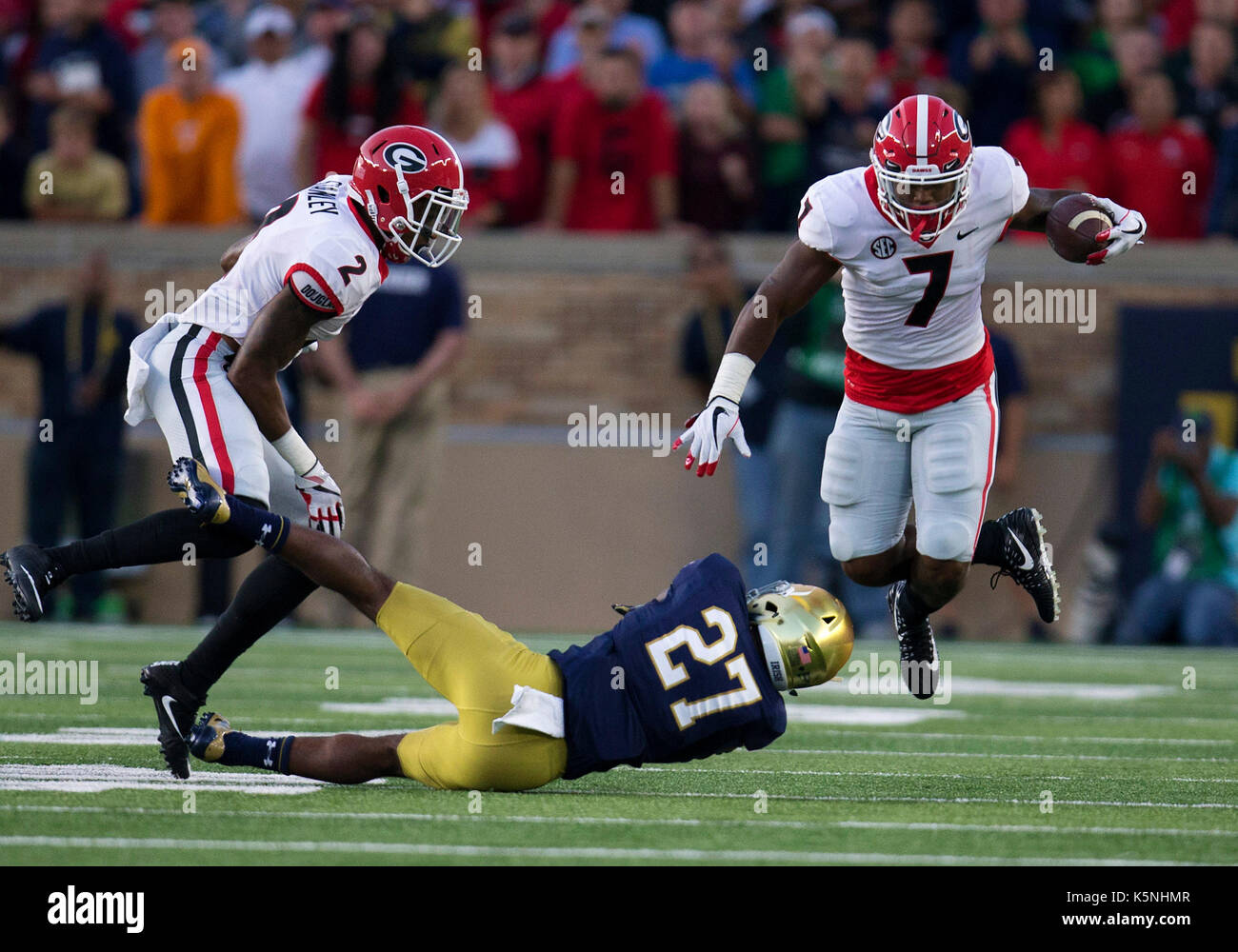 South Bend, Indiana, USA. 09th Sep, 2017. Georgia running back D'andre Swift (7) runs with the ball as Notre Dame cornerback Julian Love (27) attempts to make the tackle during NCAA football game action between the Georgia Bulldogs and the Notre Dame Fighting Irish at Notre Dame Stadium in South Bend, Indiana. Georgia defeated Notre Dame 20-19. John Mersits/CSM/Alamy Live News Stock Photo