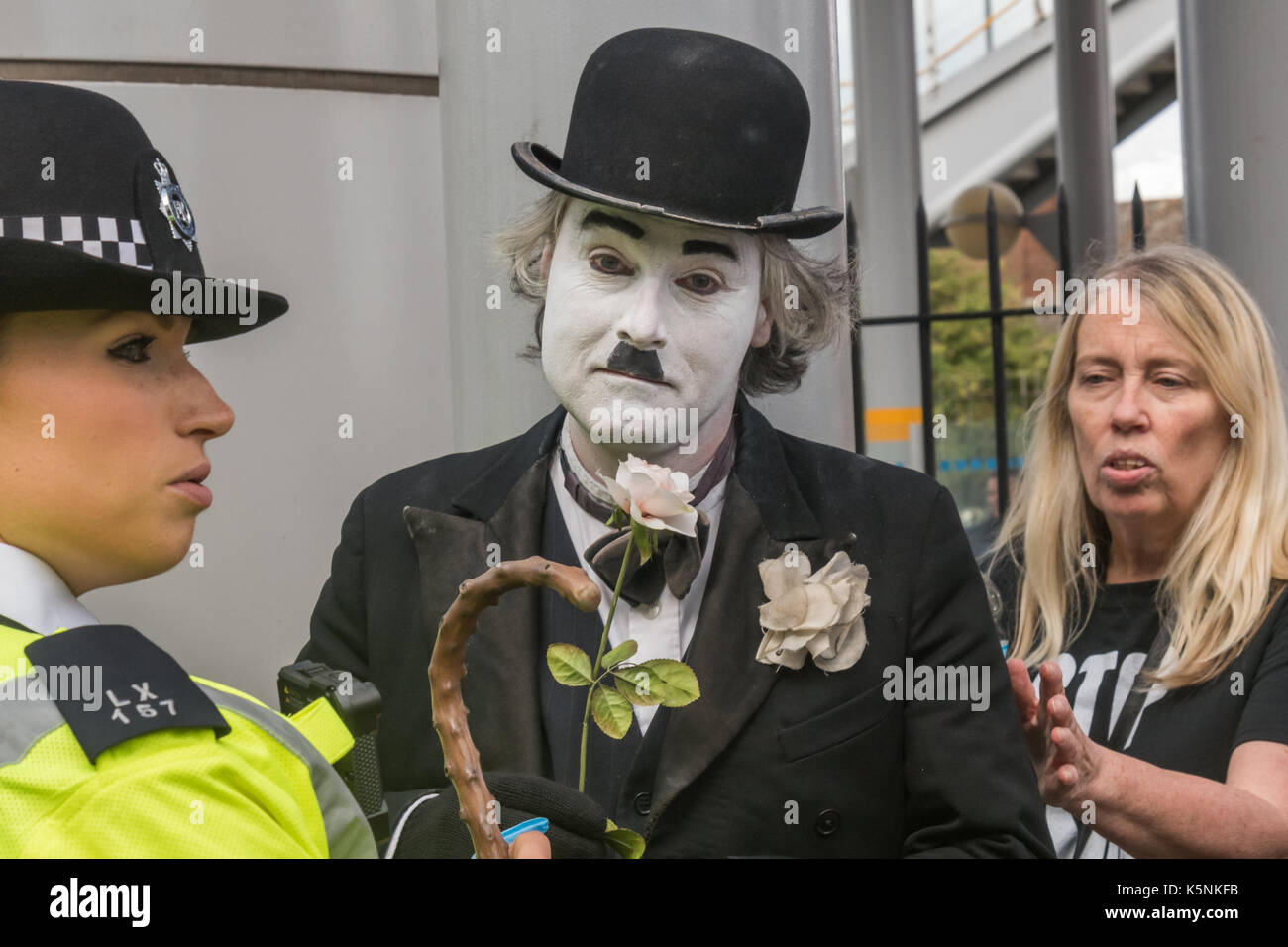 London, UK. 9th Sep, 2017. London, UK. 9th September 2017.Police arrest Charlie X, a Chaplin clone who tried to block a lorry at the West Gate of the DSEI arms fair, The Defence & Security Equipment International is the worlds largest arms fair, backed by the UK government, where arms companies and arms dealers sell weapons to countries around the world including many repressive regimes. Police at the West gate also inexplicably arrested a cyclist who was found to be in possession of a bike lock. Back at the East Gate there was a lock-on by two protesters stopping up a lorry and other p Stock Photo