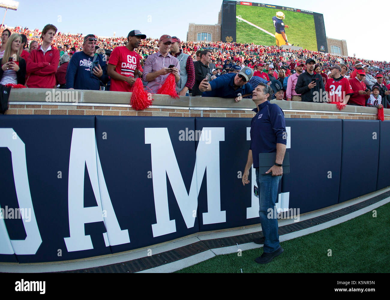 South Bend, Indiana, USA. 09th Sep, 2017. ESPN personality Mike Golic stops to take a photo with Georgia fans prior to NCAA football game action between the Georgia Bulldogs and the Notre Dame Fighting Irish at Notre Dame Stadium in South Bend, Indiana. Georgia defeated Notre Dame 20-19. John Mersits/CSM/Alamy Live News Stock Photo