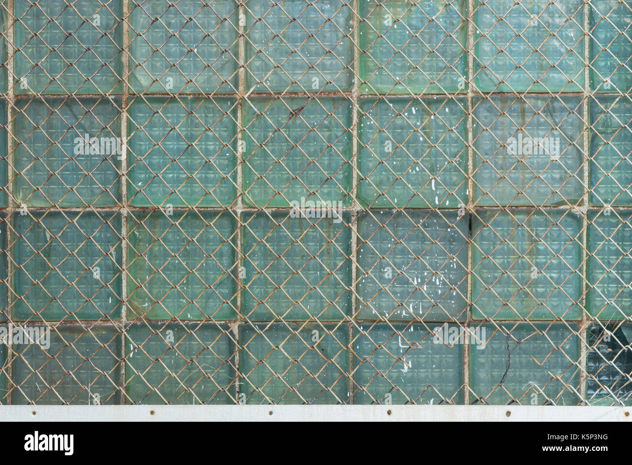 Background from the metal gauze of the chain-link and glass blocks Stock Photo