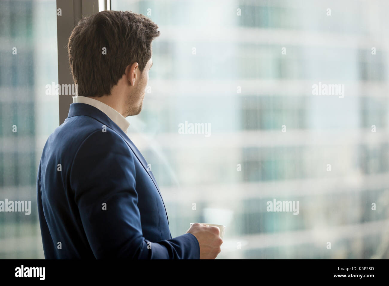 Businessman thinking about decision in office Stock Photo