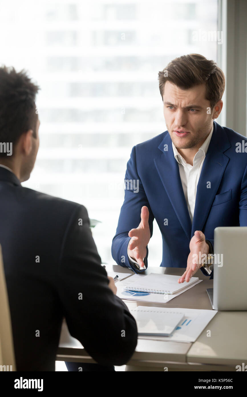 Focused CEO explaining perspectives to partner Stock Photo
