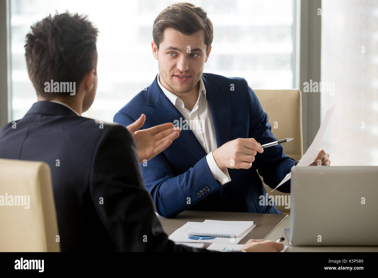 CEO discussing financial strategy with partner Stock Photo