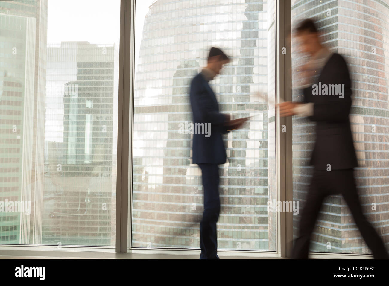 Busy businessman hurrying on business in office Stock Photo