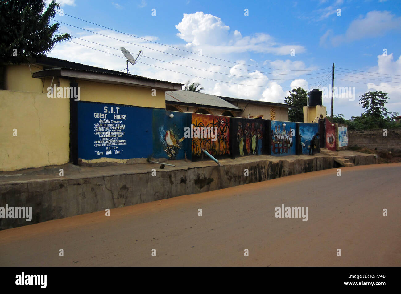 Guest house building with paintings in the fence, in the city of Akure, capital of Ondo State, Nigeria Stock Photo