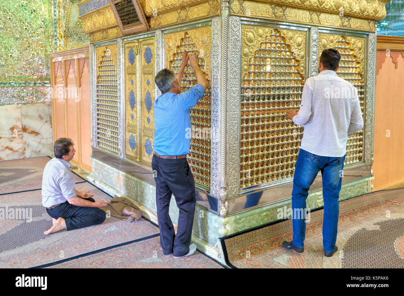 Fars Province, Shiraz, Iran - 18 april, 2017:  Worshippers praying  inside mirrored mosque,  they worship mausoleum of Sayyed Alaeddin Hossein. Stock Photo