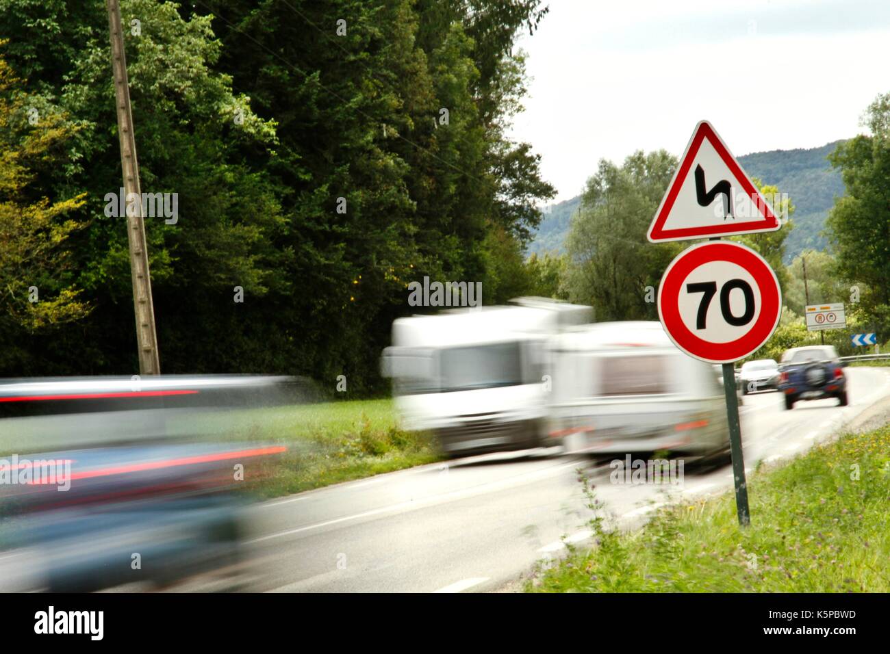 Speed limitation for cars, trucks, motor vehicles, car traffic, with a sign indicating a maximum speed of 70 kilometers on a national in France Stock Photo