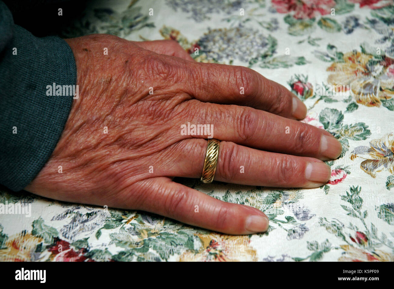 Elderly man's hand with wedding ring Stock Photo