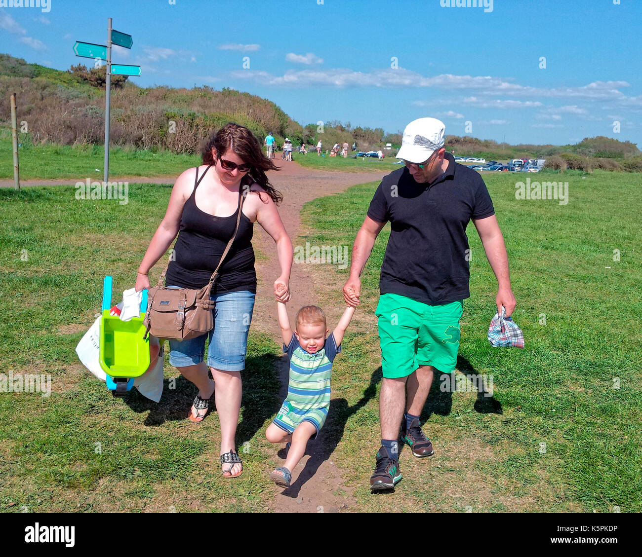 young family boy child going to the beach sunny summer day Irvine Beach Park, Irvine, Stock Photo