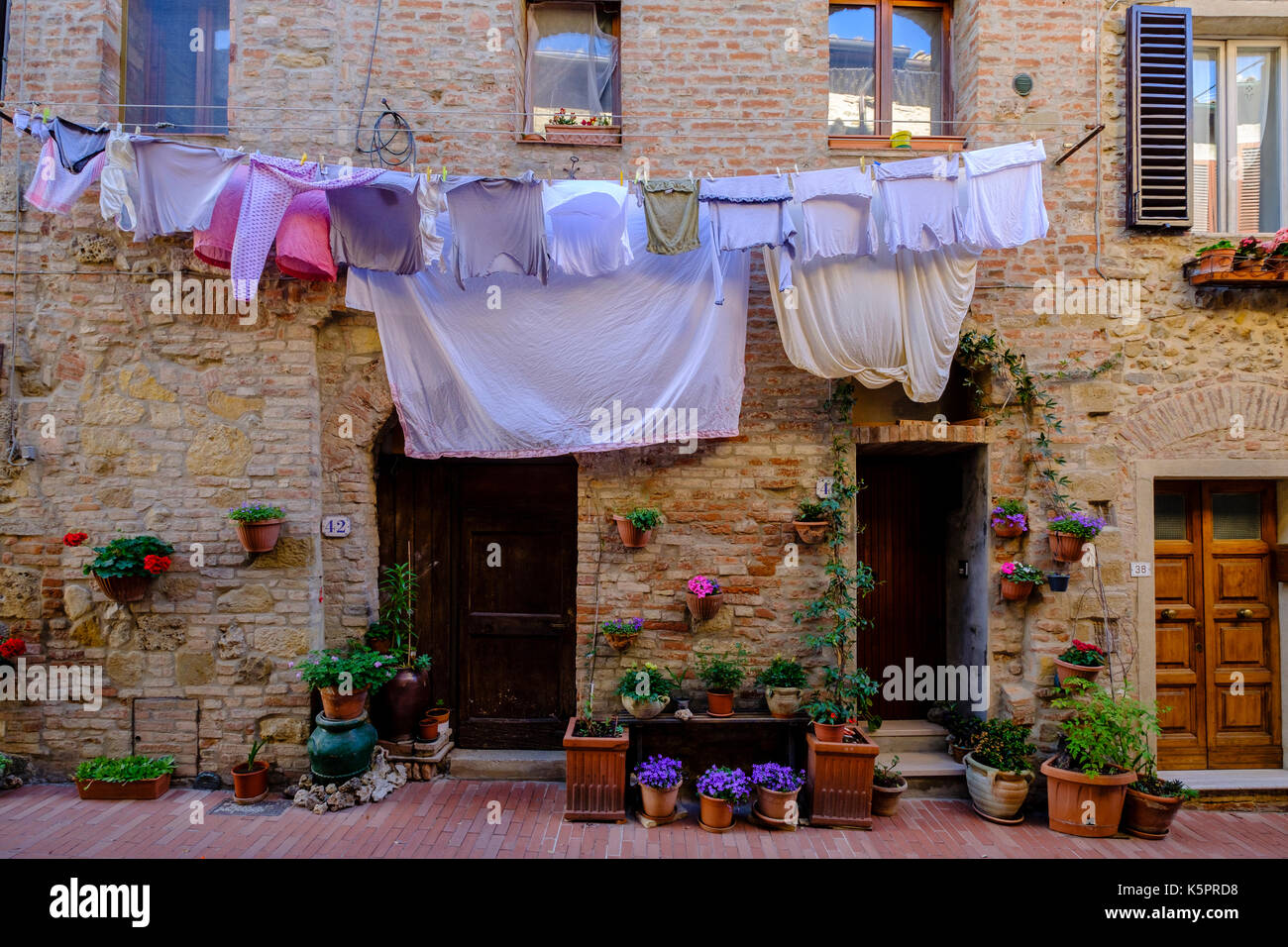 Laundry is put to dry at the facade of an old house in the medieval town Stock Photo