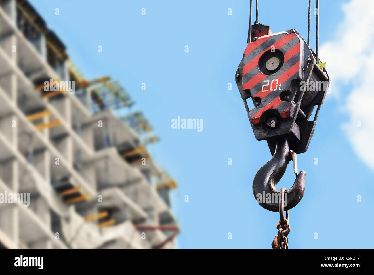 building construction site - crane hook against blue sky Stock Photo