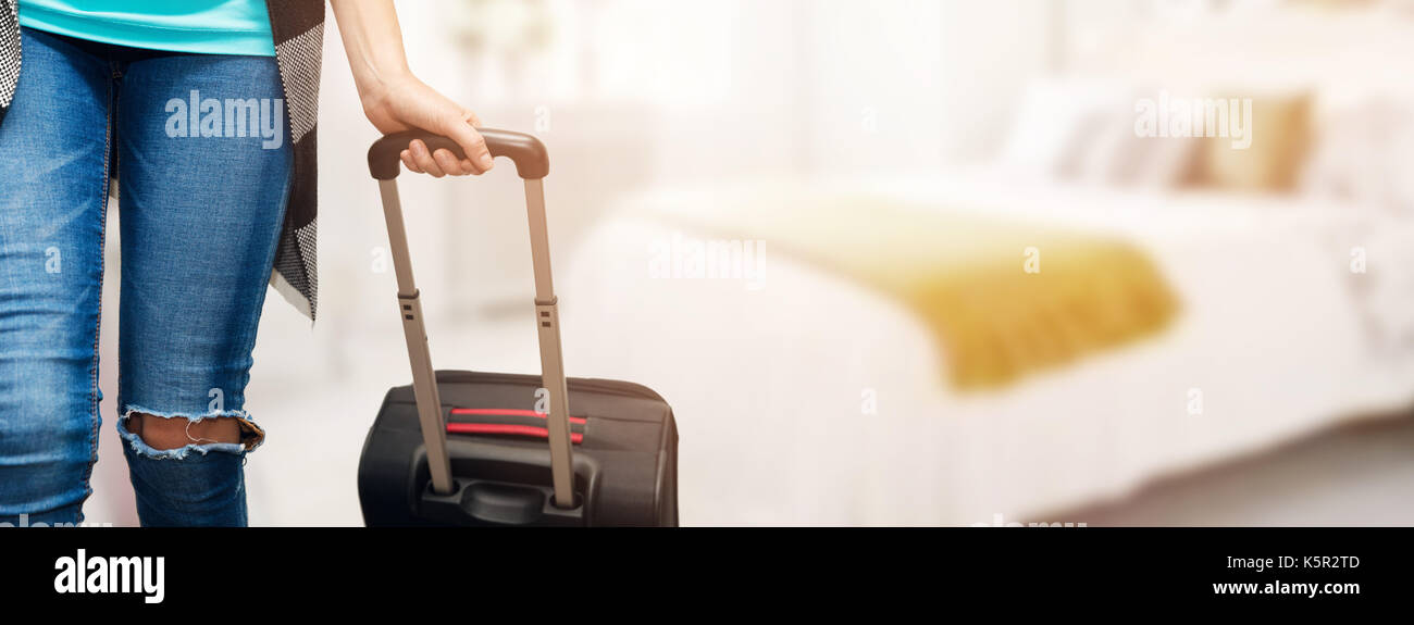 time for vacations - woman with luggage suitcase in bedroom ready for travel Stock Photo