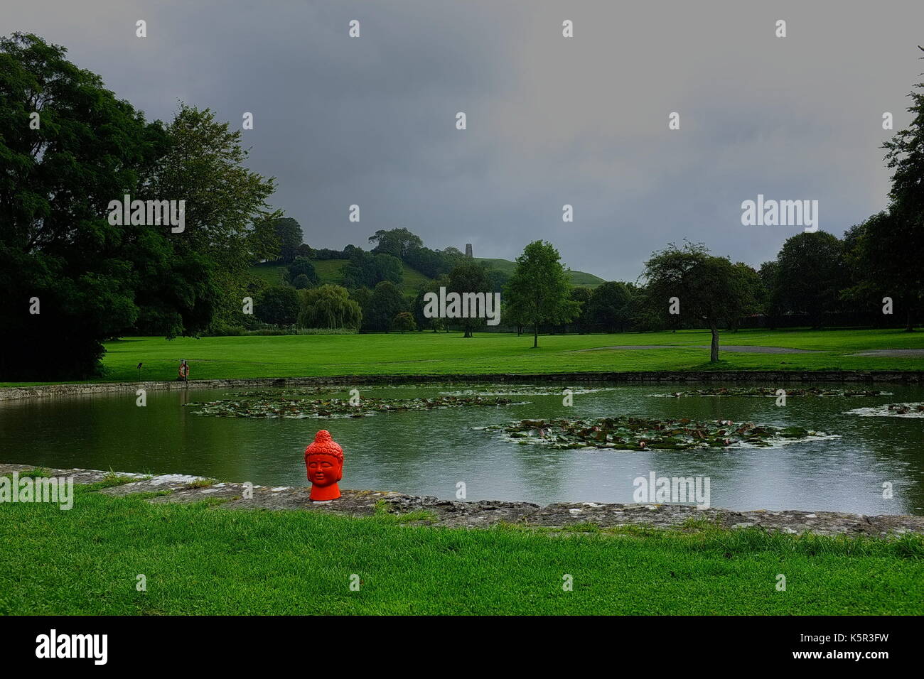 Pond at Glastonbury Abbey, featuring Buddha Stock Photo Alamy