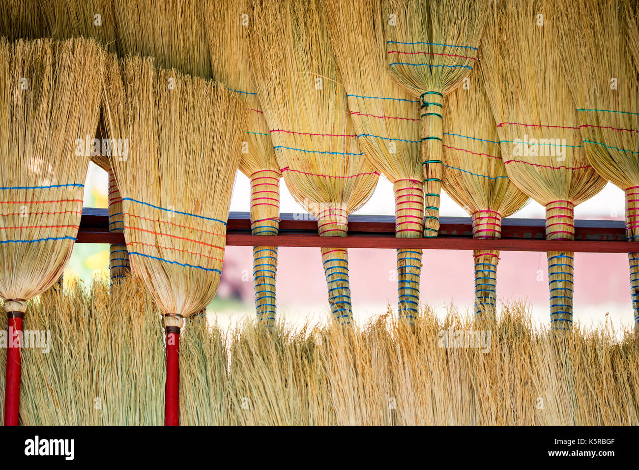 Several new straw brooms on market Stock Photo Alamy